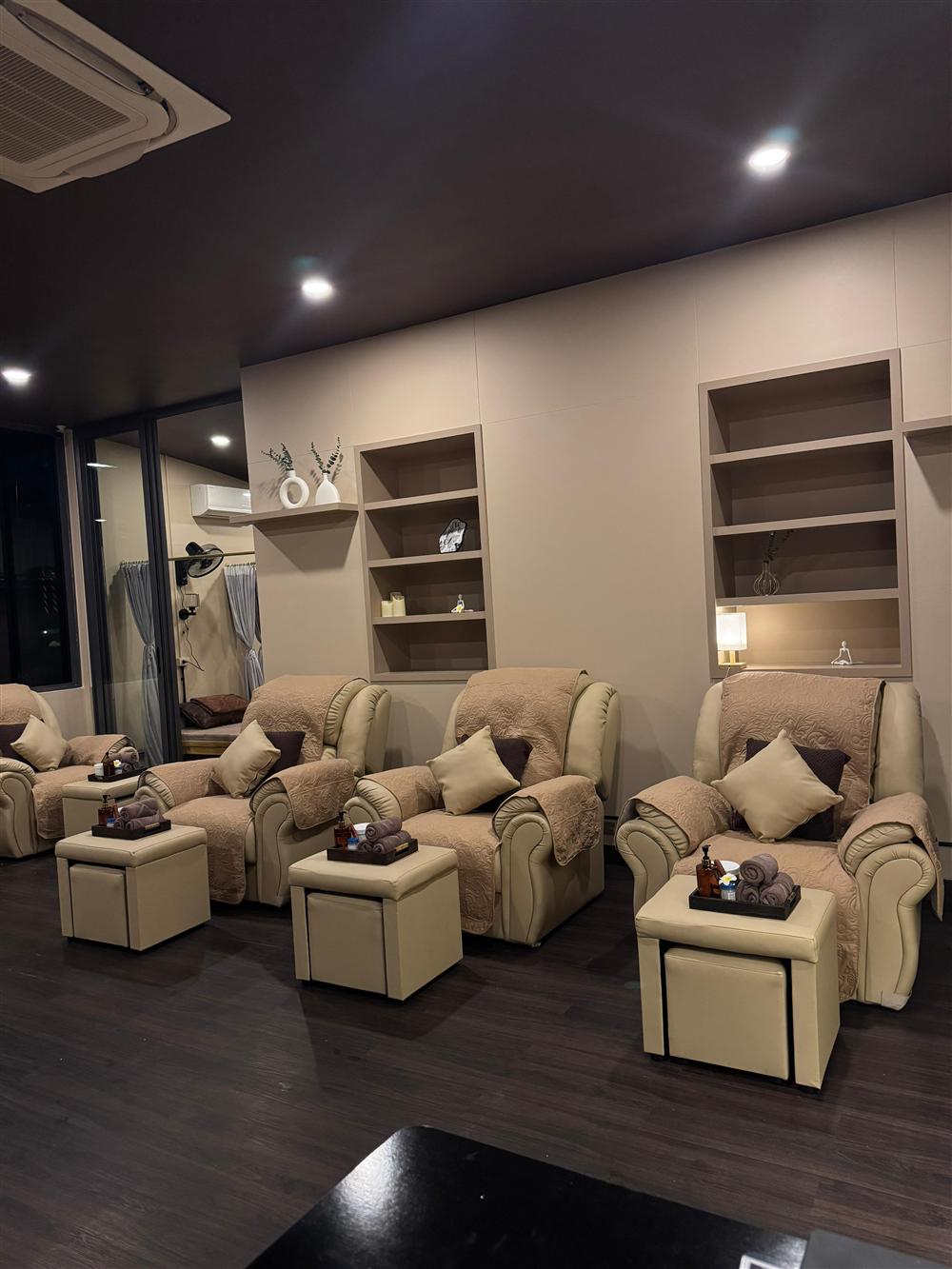 Cream recliners and warm shelving inside the Outback Massage lounge
